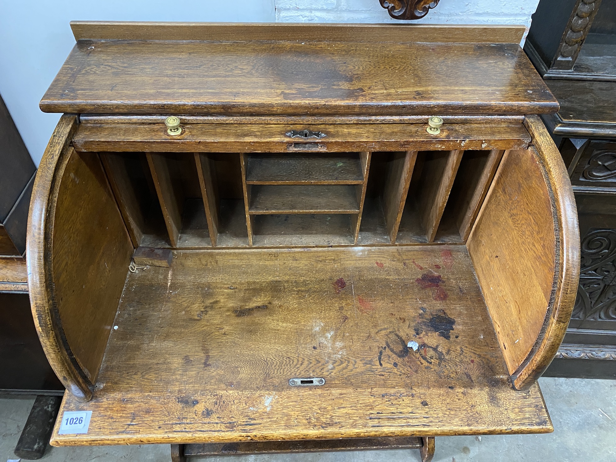 An early 20th century oval tambour roll top desk, combined bookcase, width 75cm, depth 53cm, height 108cm